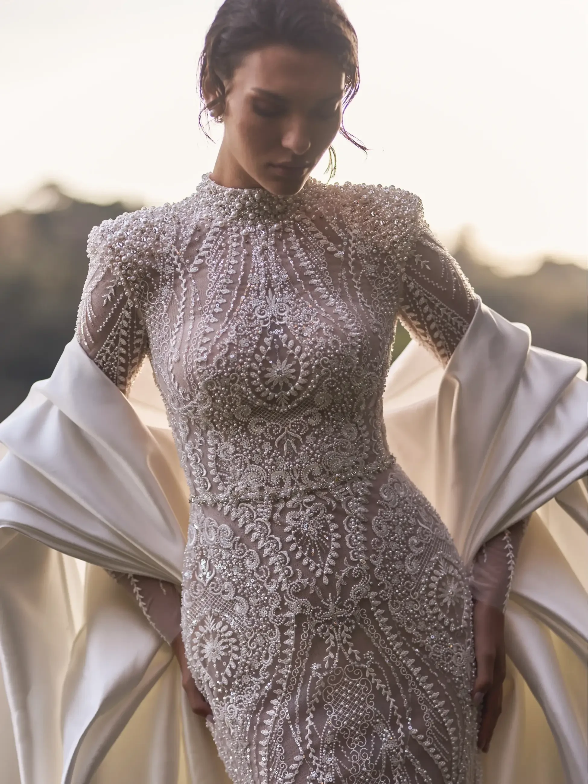 model is wearing a beaded bold bridal gown