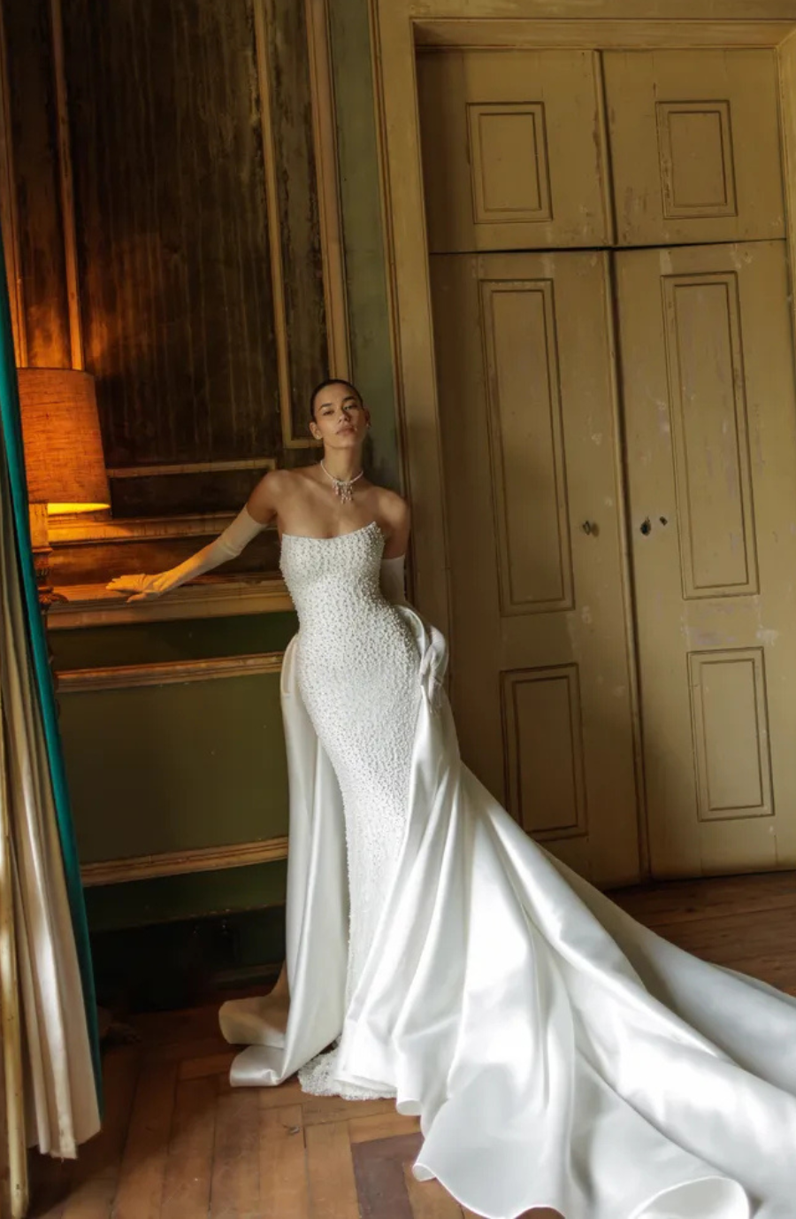model wears a strapless fit and flare bridal gown