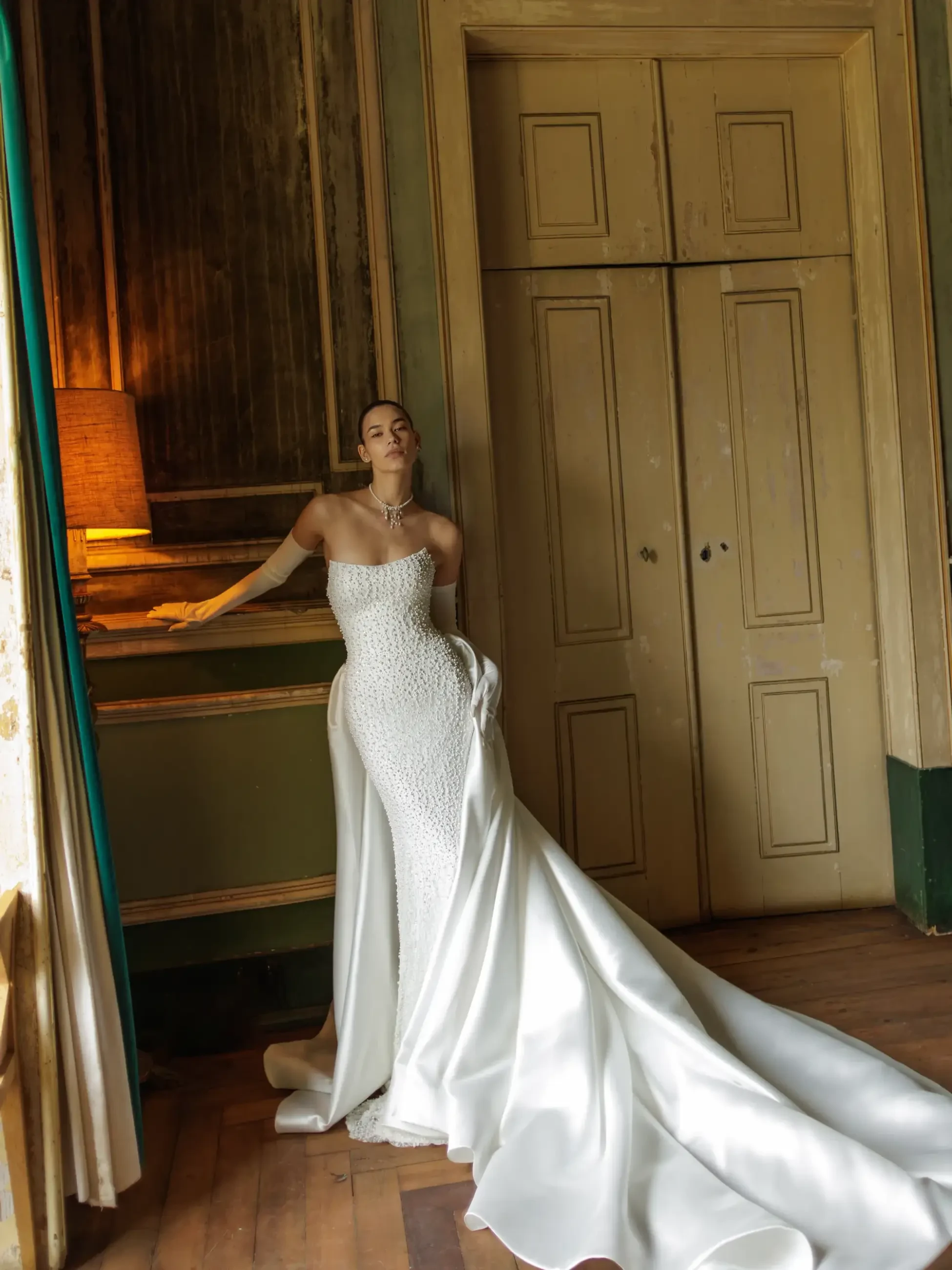 Model is wearing a minimalist dress with clean lines and subtle details, creating an effortlessly elegant silhouette.