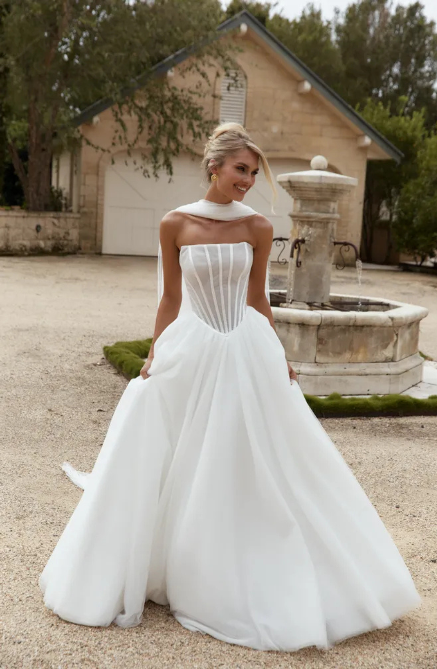 model wears a strapless ball gown