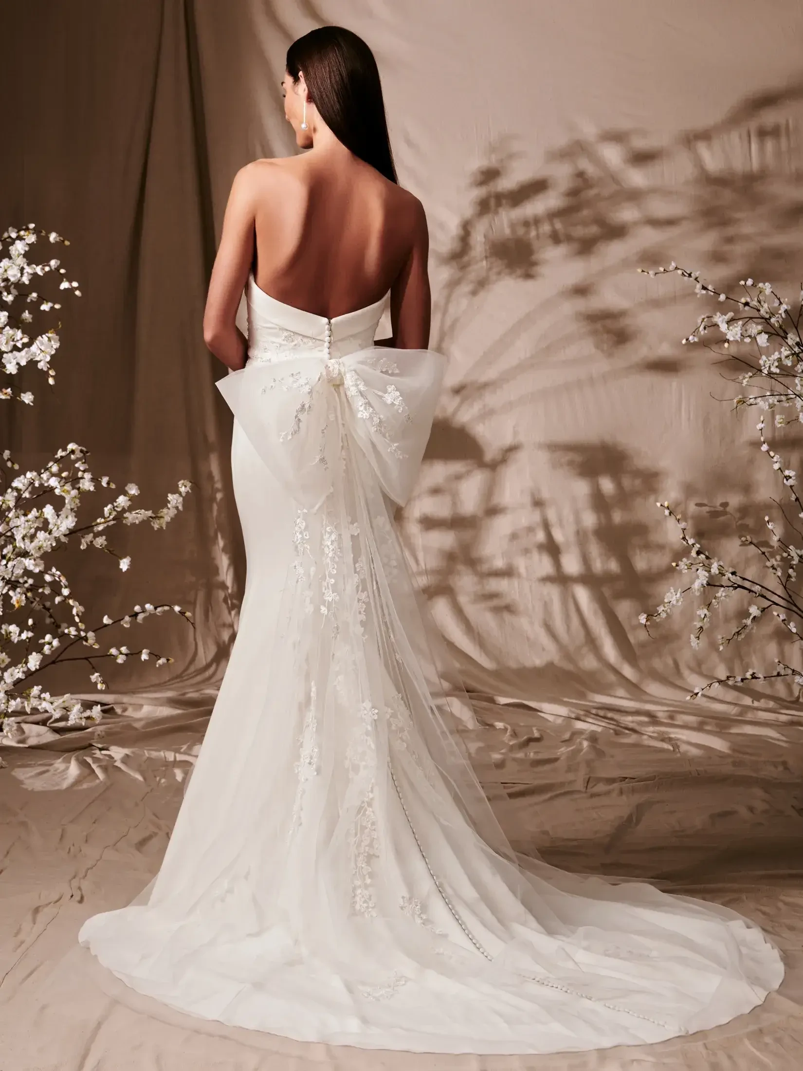 model is wearing a strapless fit and flare wedding dress