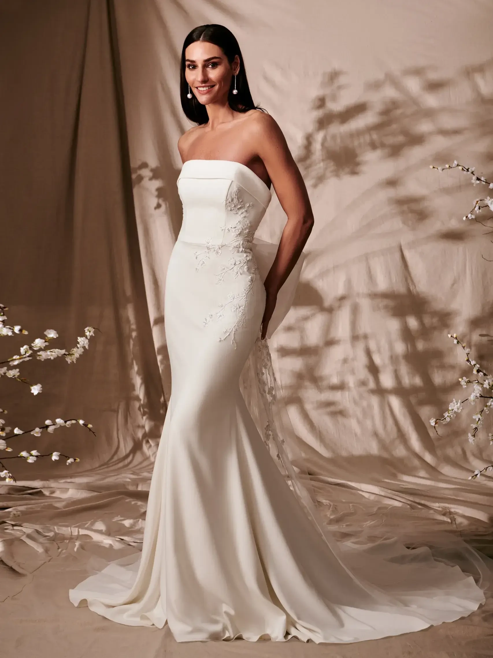 model is wearing a strapless fit and flare wedding dress