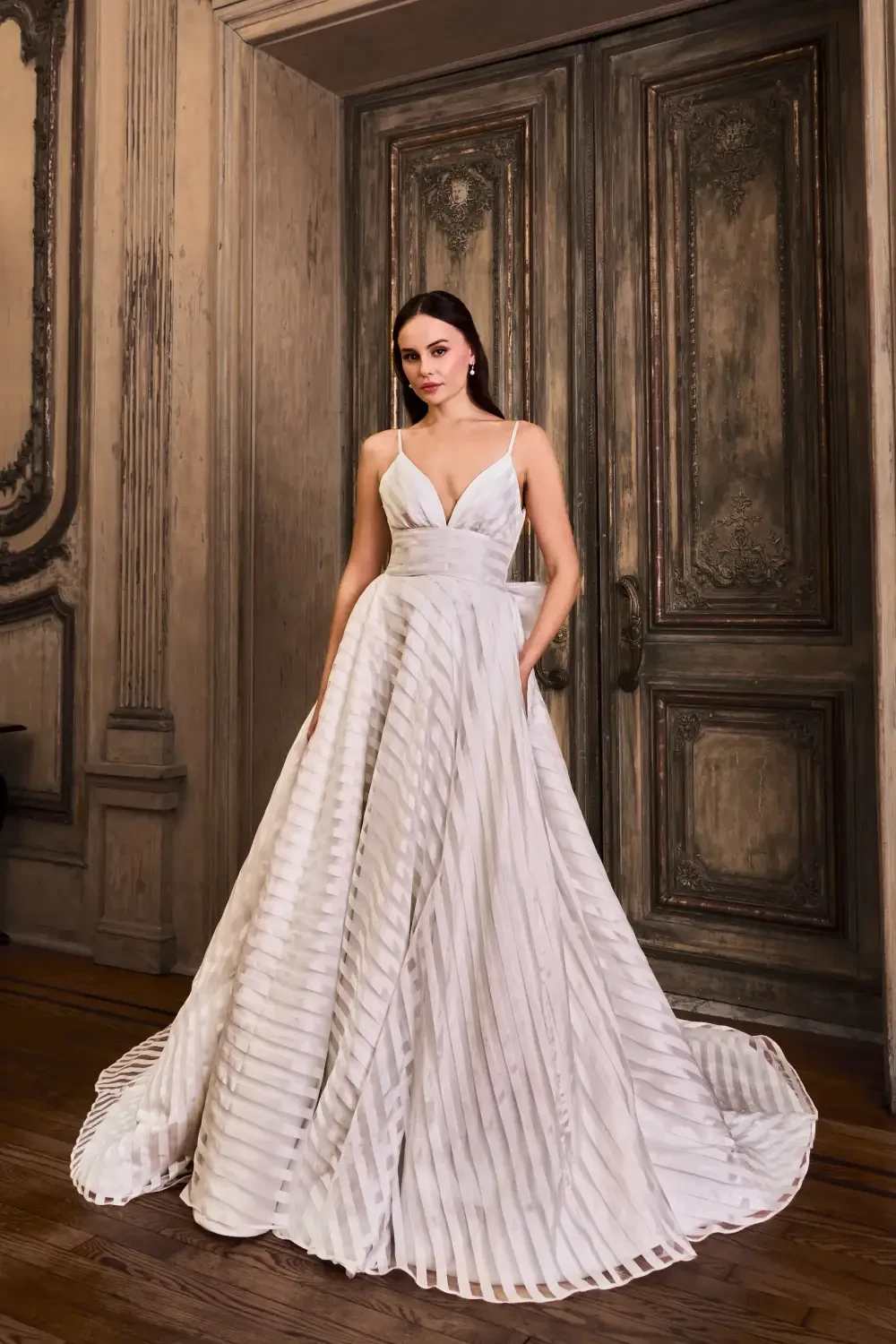 model is wearing a sleeveless bridal gown