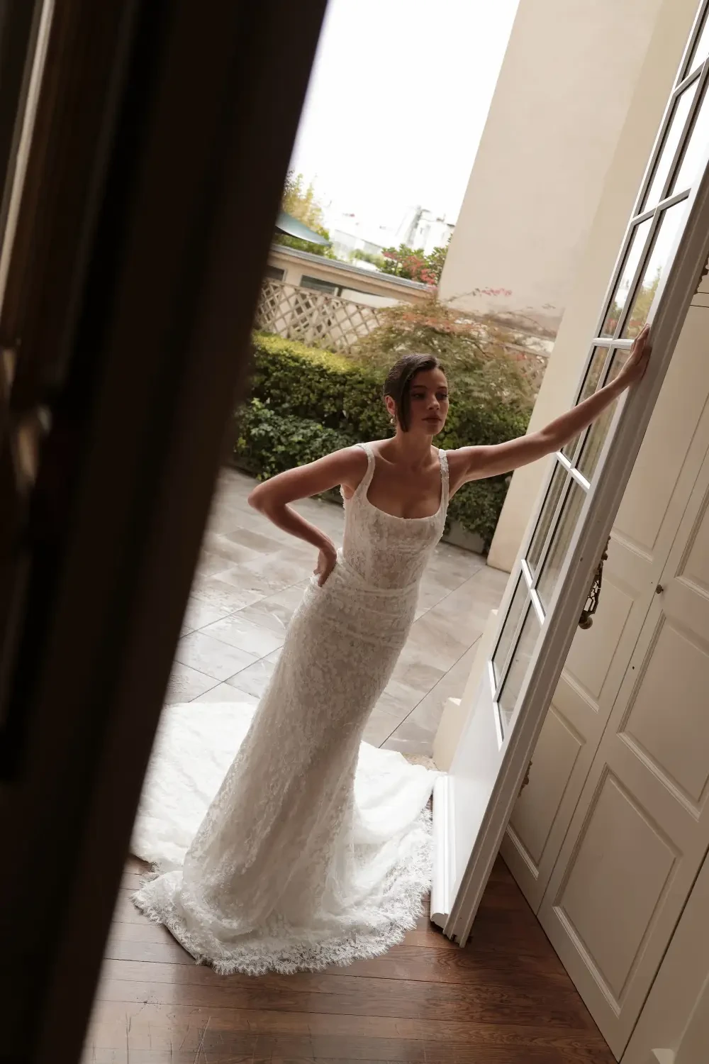 model is wearing a lace bridal gown from trish peng