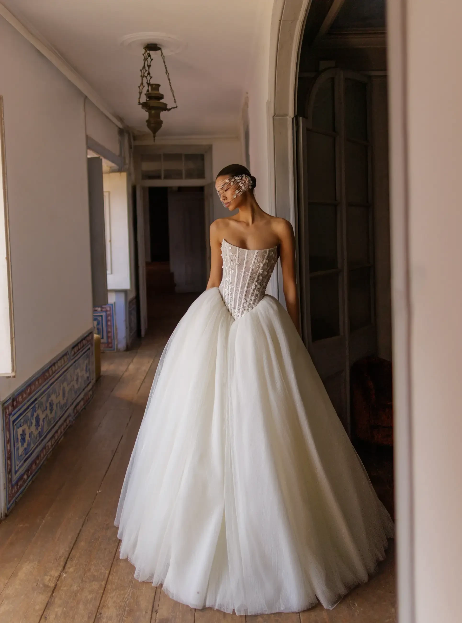 model is wearing a strapless basque waist wedding dress
