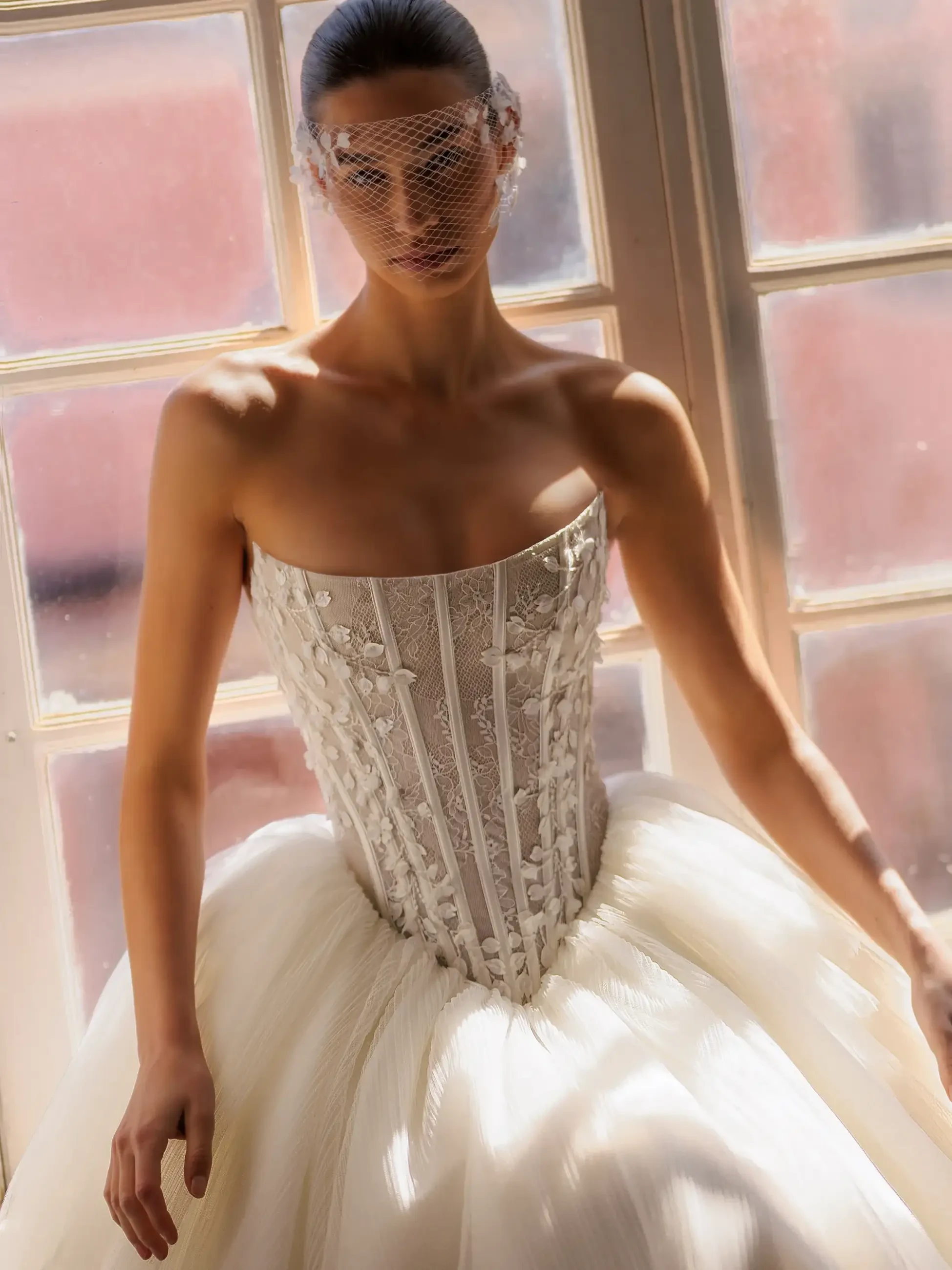 model is wearing a strapless basque waist wedding dress