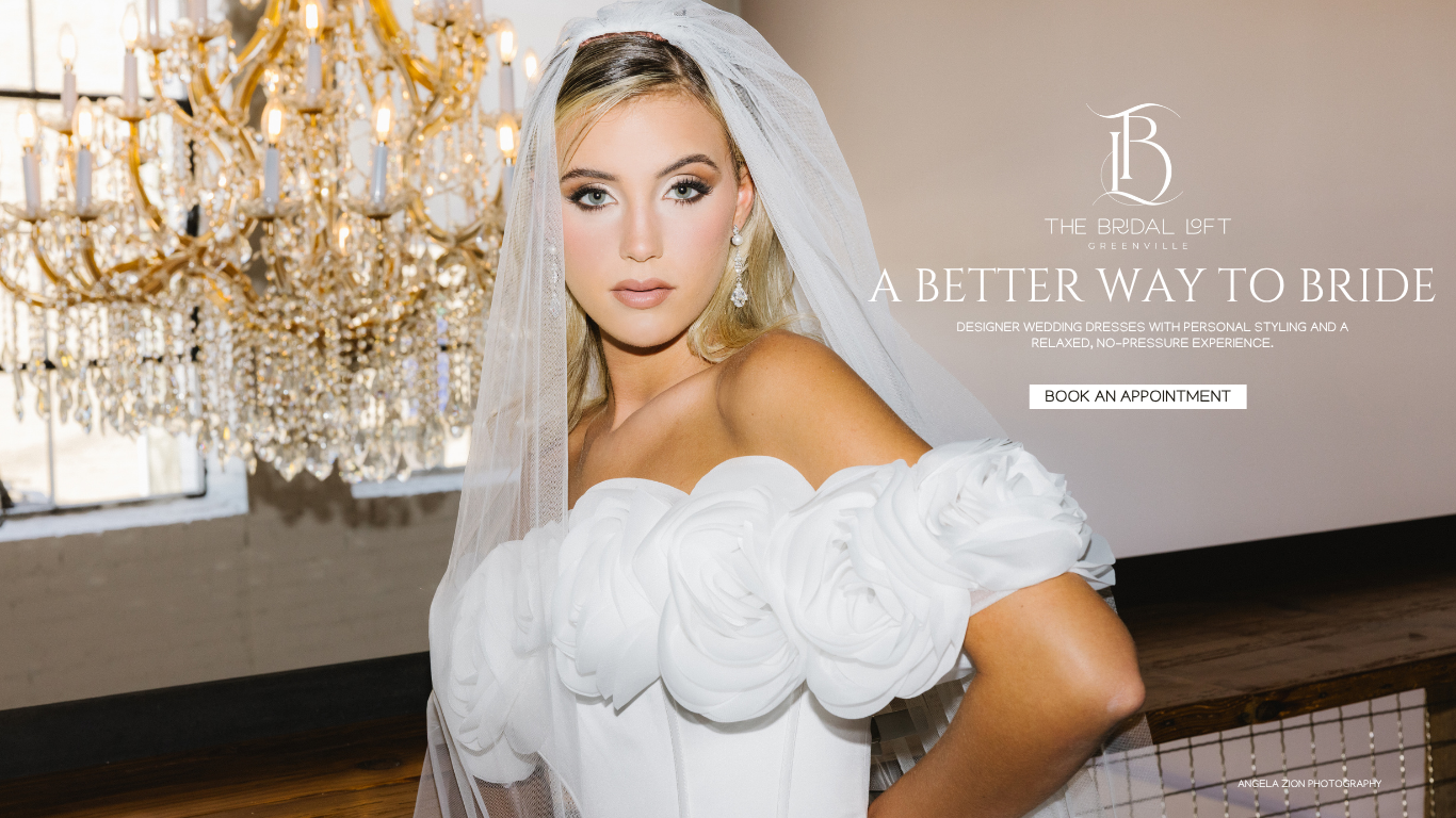 model in wedding dress and veil with chandelier in background